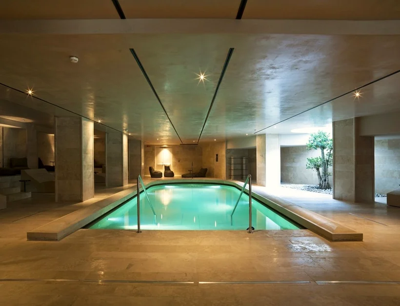 A calm indoor pool with warm lighting