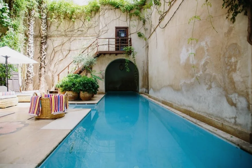 A narrow pool in a stone courtyard